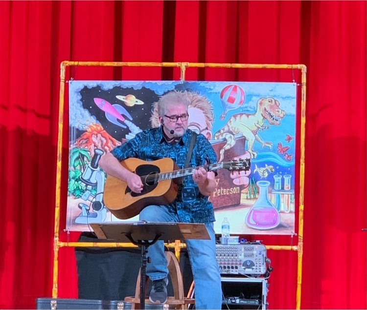 Randy Peterson sings to students